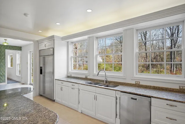 a kitchen with granite countertop a sink and a window