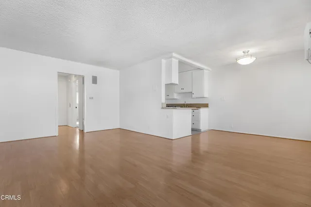 a view of kitchen with wooden floor and electronic appliances