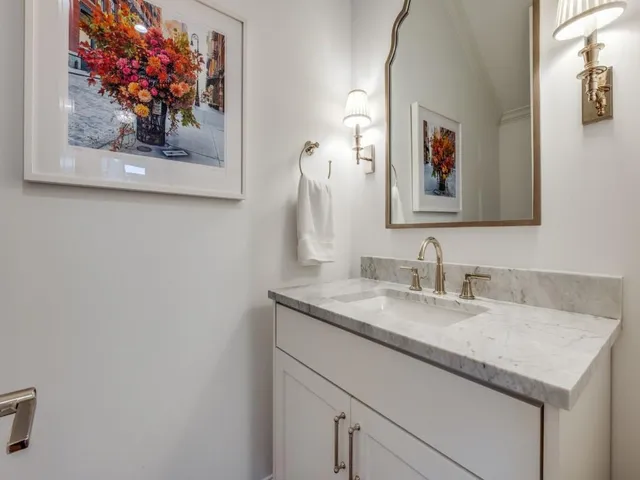 a bathroom with a sink vanity and a granite