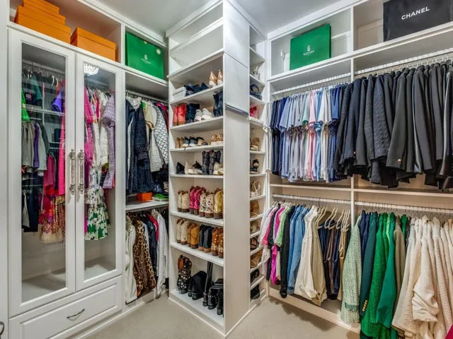 a view of walk in closet with clothes and shoes