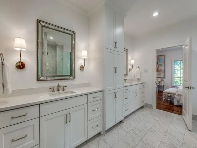 a spacious bathroom with 2 sink and a mirror