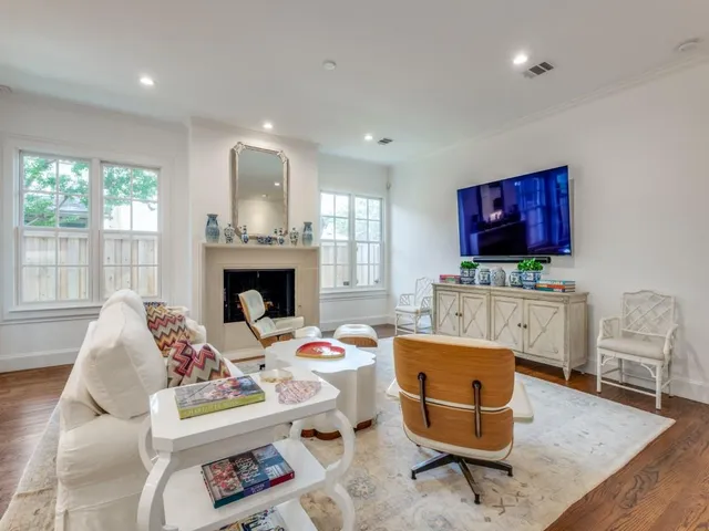 a living room with furniture fireplace and window