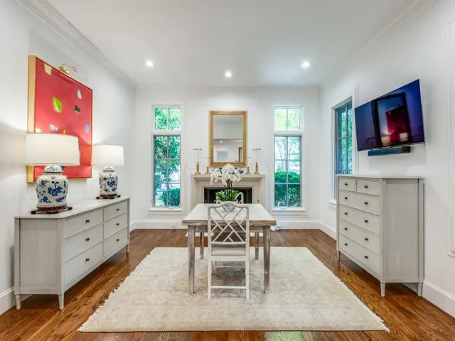 a living room with furniture a flat screen tv and a floor to ceiling window