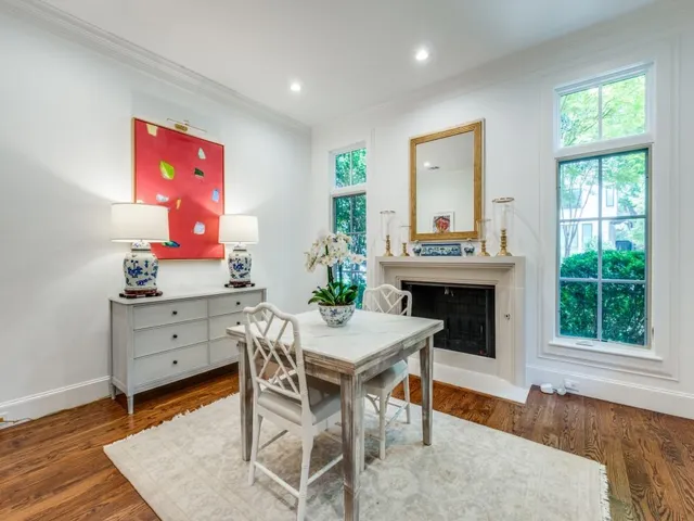 a view of a dining room with furniture and a fireplace