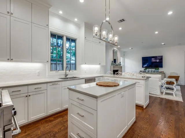 a kitchen with a sink stove and cabinets