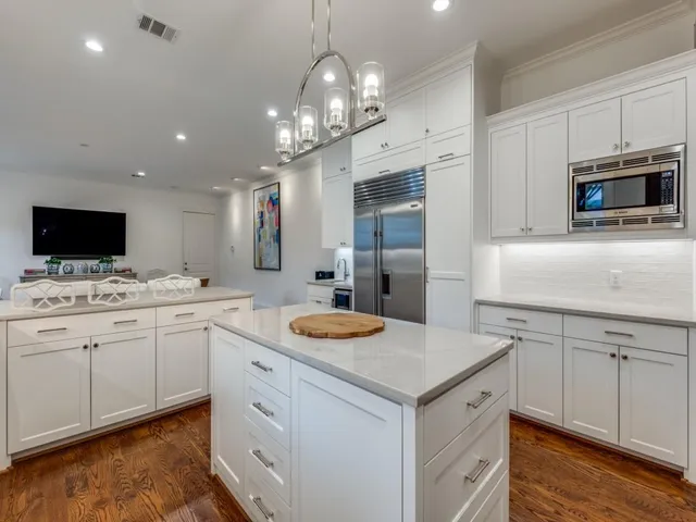 a kitchen with sink cabinets and stainless steel appliances