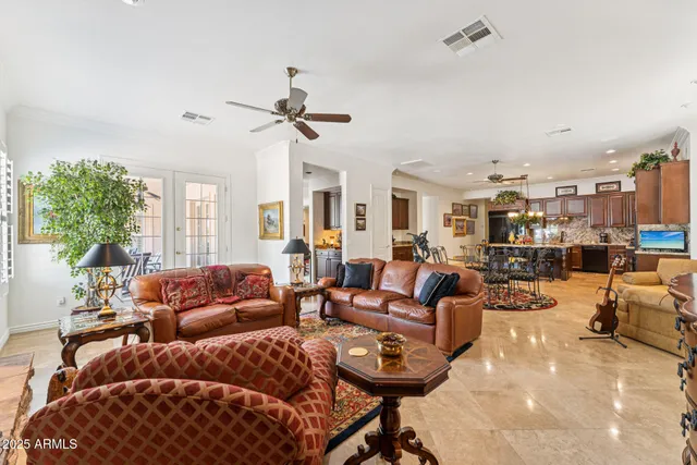 a living room with furniture a fireplace and a large window