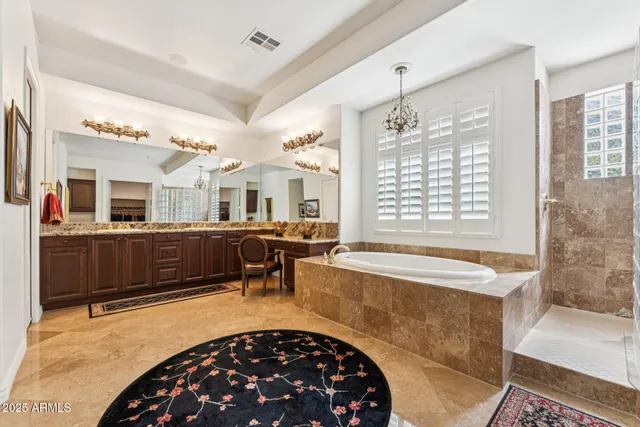 a bedroom with two beds and a flat screen tv