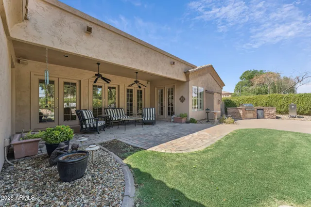 a view of a patio with a table chairs and a yard