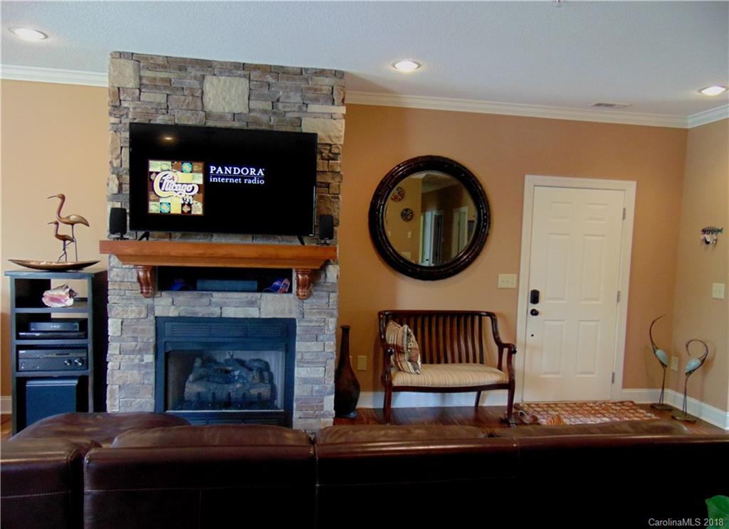 2010 Marina Pointe Road, Unit 2010 Salisbury, NC 28146 - Photo 11 of 28 a living room with furniture a mirror and a fireplace