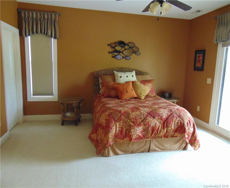 2010 Marina Pointe Road, Unit 2010 Salisbury, NC 28146 - Photo 13 of 28 a bed sitting in a bedroom next to a window