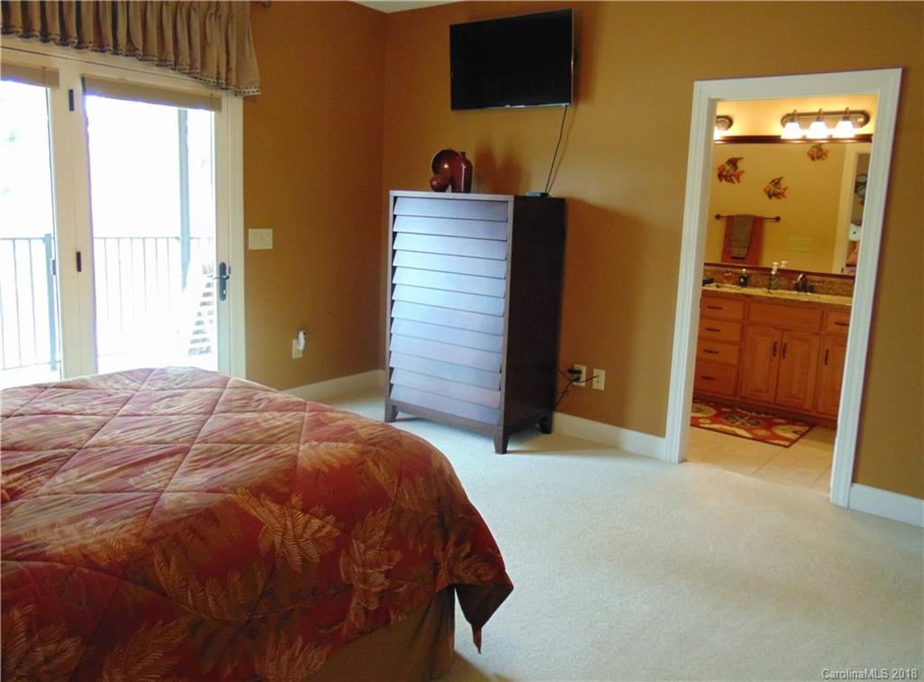 2010 Marina Pointe Road, Unit 2010 Salisbury, NC 28146 - Photo 14 of 28 a bedroom with a bed and a mirror