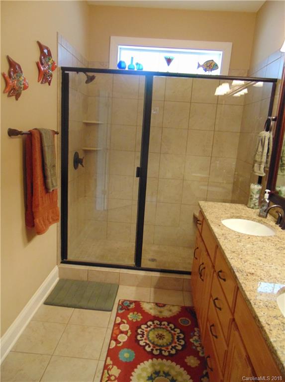 2010 Marina Pointe Road, Unit 2010 Salisbury, NC 28146 - Photo 16 of 28 a bathroom with a granite countertop shower and a sink