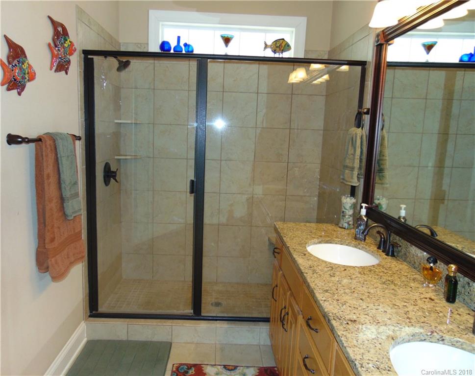 2010 Marina Pointe Road, Unit 2010 Salisbury, NC 28146 - Photo 17 of 28 a bathroom with a granite countertop shower a sink and a mirror