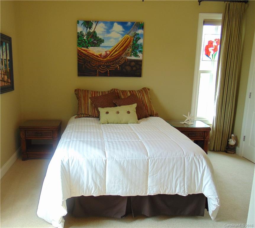 2010 Marina Pointe Road, Unit 2010 Salisbury, NC 28146 - Photo 18 of 28 a bedroom with a bed and painting on the wall