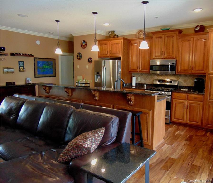 2010 Marina Pointe Road, Unit 2010 Salisbury, NC 28146 - Photo 4 of 28 a kitchen with a table chairs refrigerator and microwave