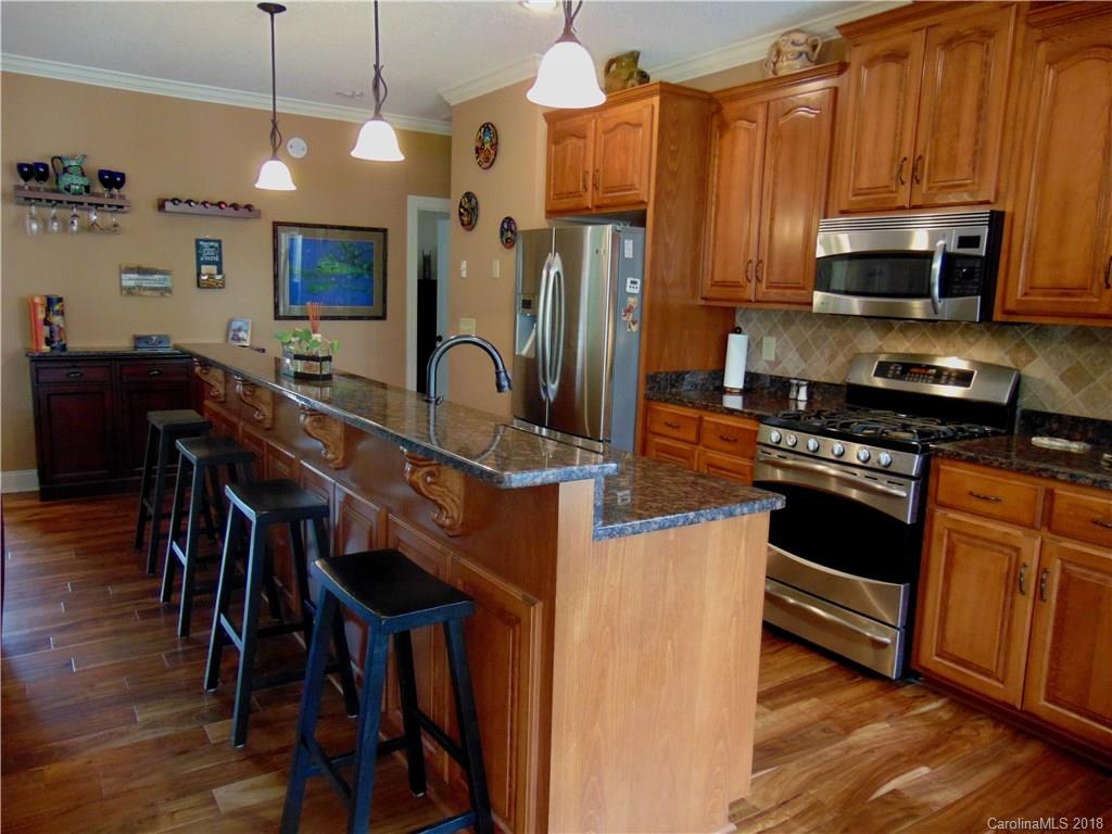 2010 Marina Pointe Road, Unit 2010 Salisbury, NC 28146 - Photo 5 of 28 a kitchen with stainless steel appliances a stove a sink a microwave a refrigerator cabinets and wooden floor