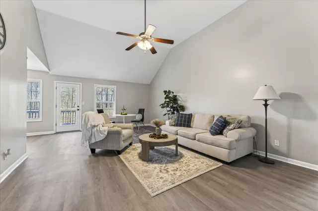 a living room with furniture and a chandelier