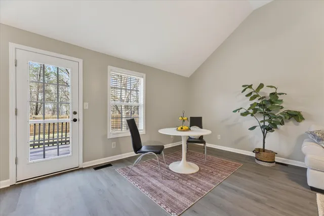 a work room with furniture wooden floor and a potted plant