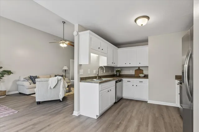 a kitchen with a sink cabinets and wooden floor