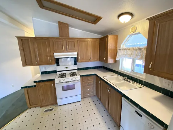 a kitchen with a stove a sink and a refrigerator