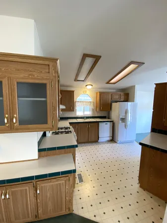 a kitchen with stainless steel appliances kitchen island granite countertop a sink and a stove