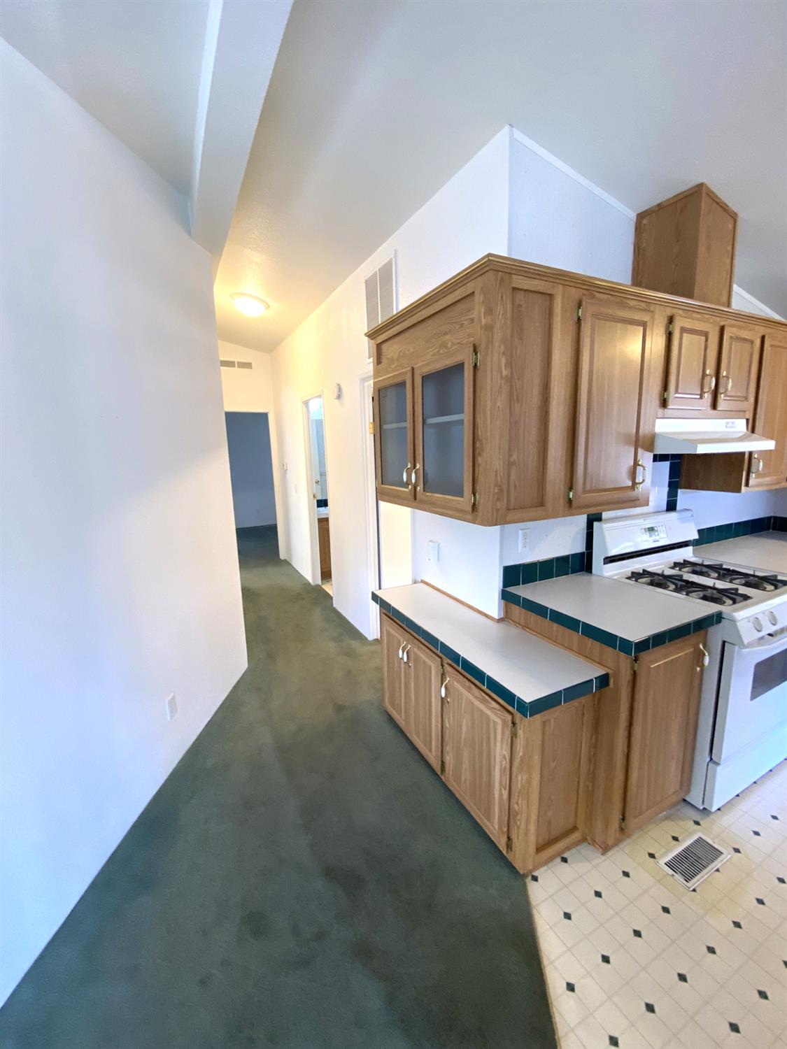 3901 Maui Terrace Modesto, CA 95355 - Photo 17 of 32 a kitchen with stainless steel appliances a sink stove and cabinets