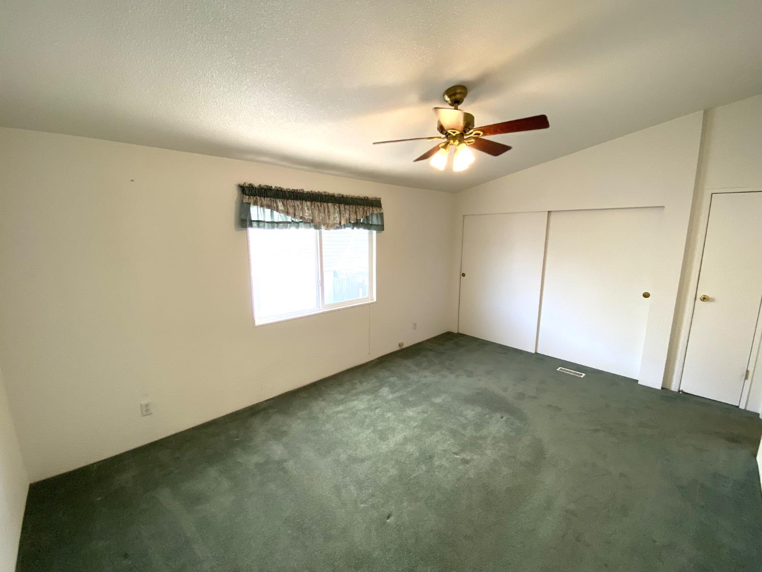 3901 Maui Terrace Modesto, CA 95355 - Photo 18 of 32 an empty room with windows and fan