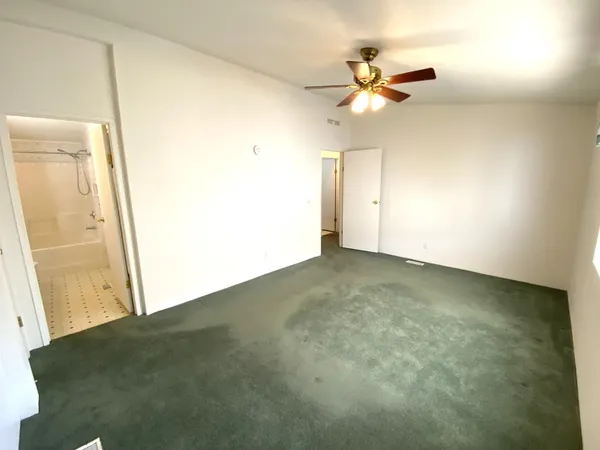 a view of a room with a ceiling fan