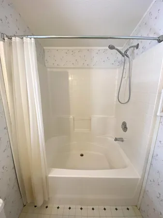 a bathroom with a shower and a tub
