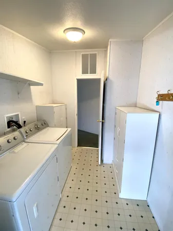a room with a washing machine and a sink