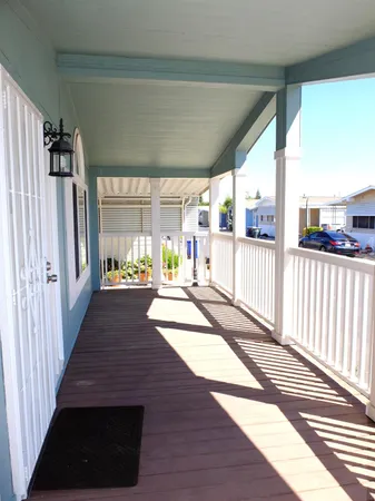 a view of a living room and a balcony