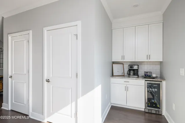 a view of a kitchen with white cabinets
