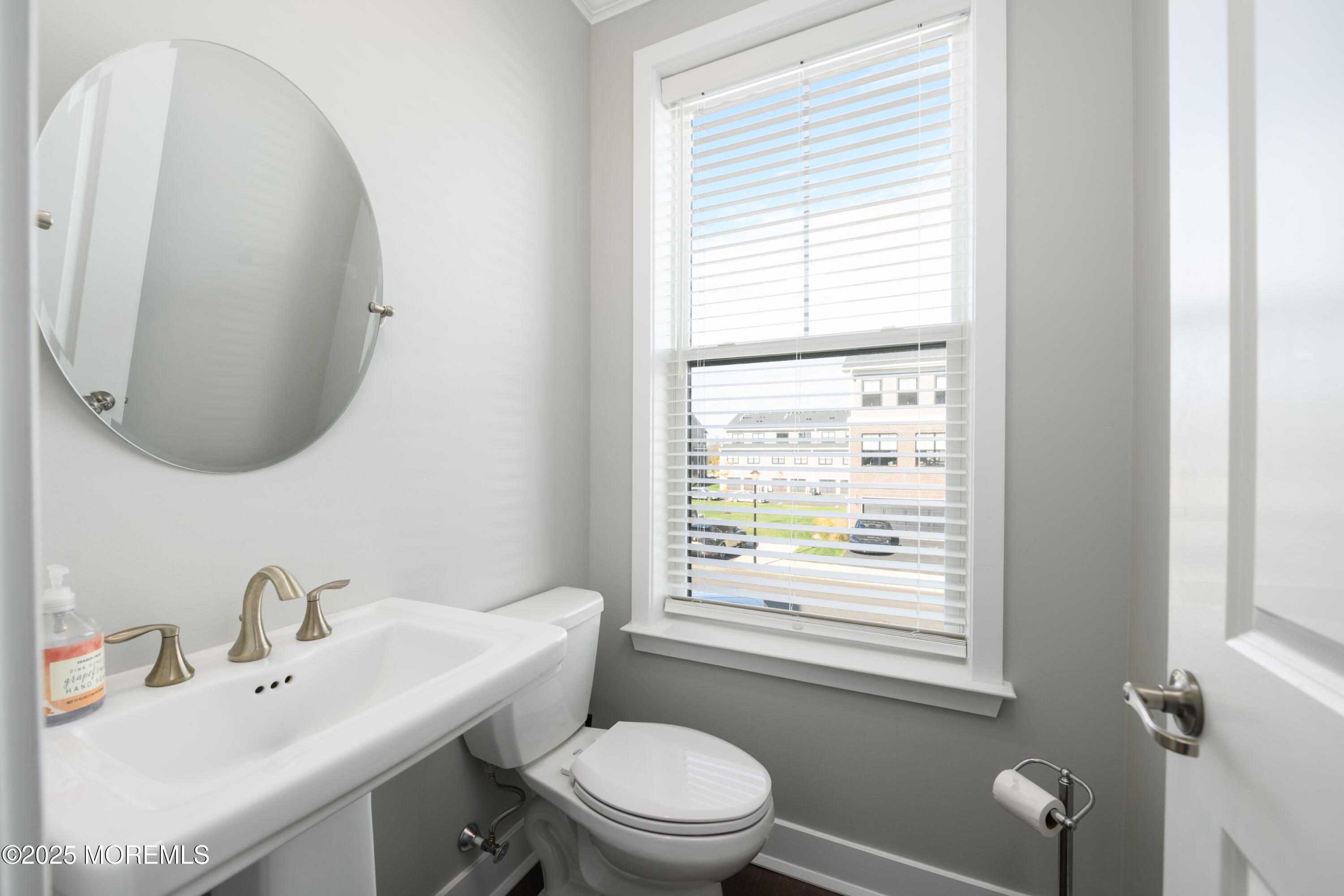 26 Kelly Way Tinton Falls, NJ 07724 - Photo 14 of 33 a bathroom with a toilet a sink a mirror and a window