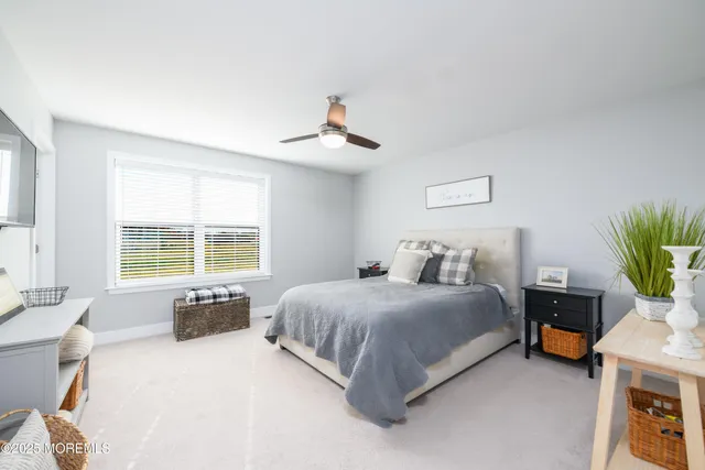 a spacious bedroom with a bed and a couch