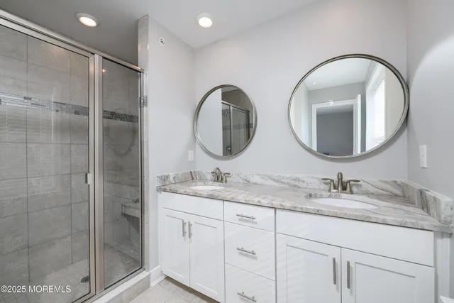 a bathroom with a double vanity sink and a mirror