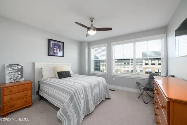 a bedroom with a bed dresser and a window