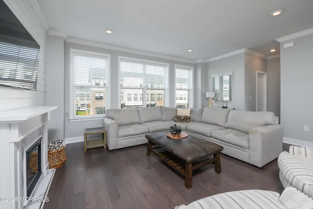 a living room with furniture a fireplace and a large window