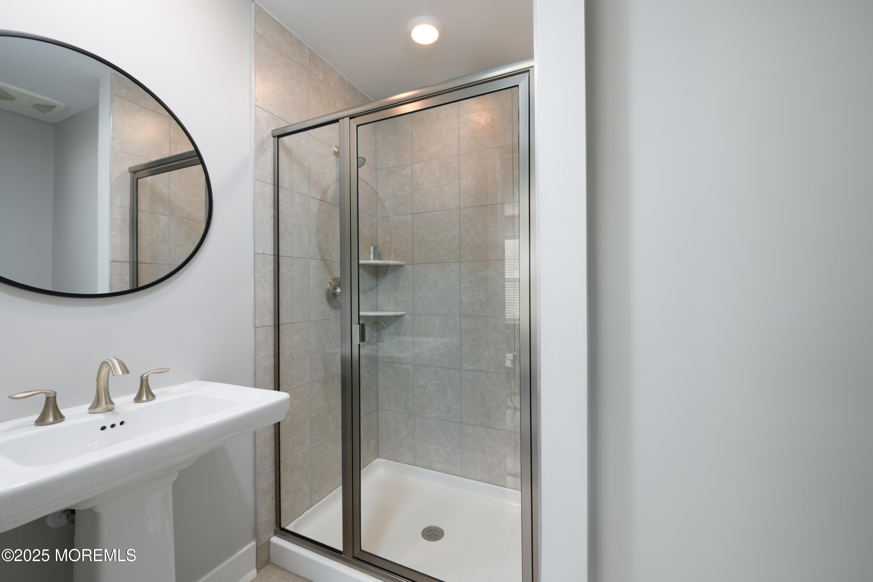 26 Kelly Way Tinton Falls, NJ 07724 - Photo 26 of 33 a bathroom with a sink mirror and shower