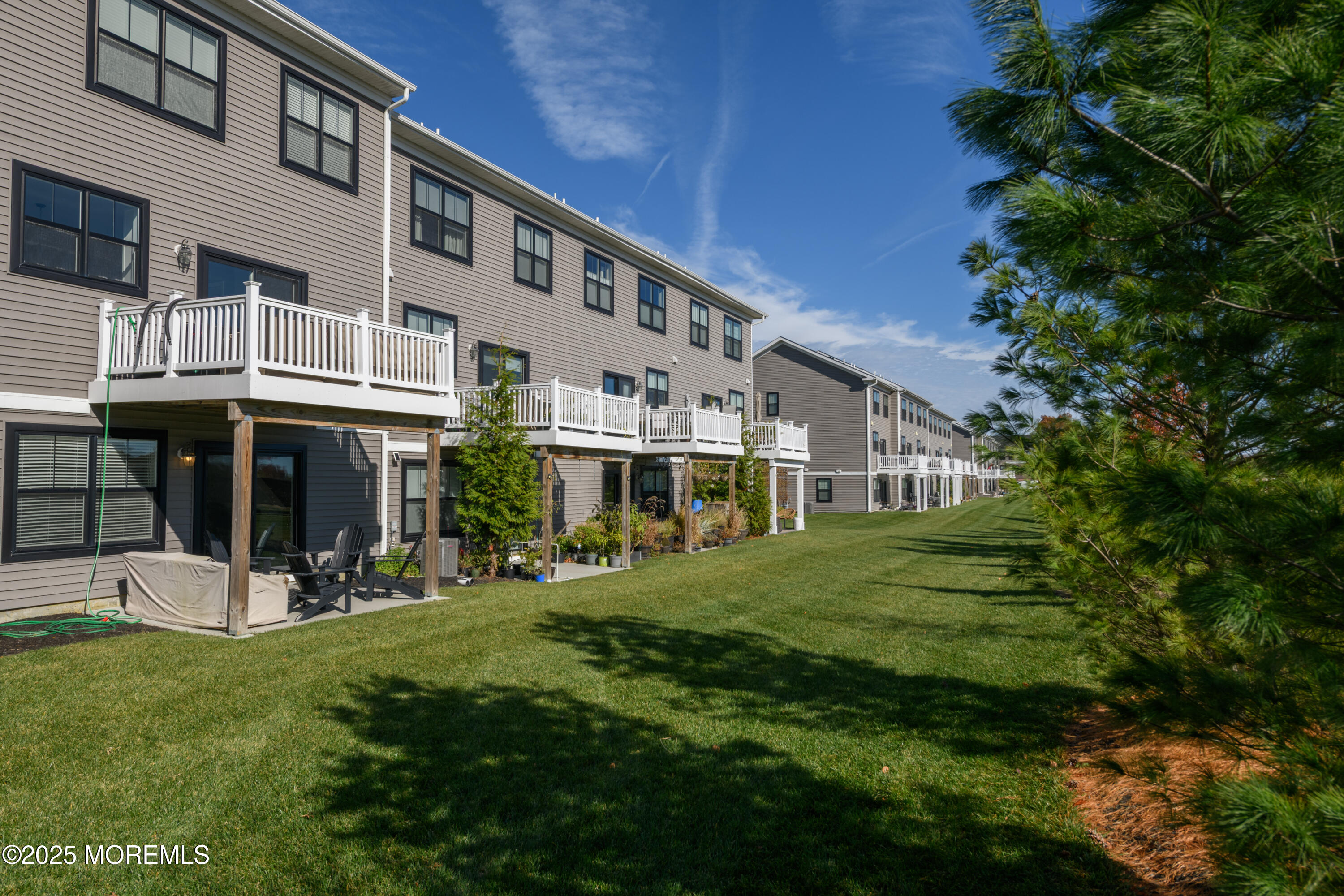 26 Kelly Way Tinton Falls, NJ 07724 - Photo 30 of 33 a front view of a house with a yard table and chairs