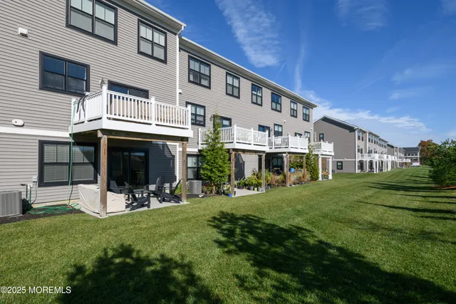 a view of a house with a yard and sitting area