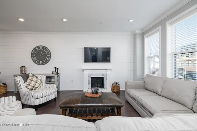 a living room with furniture a fireplace and a large window