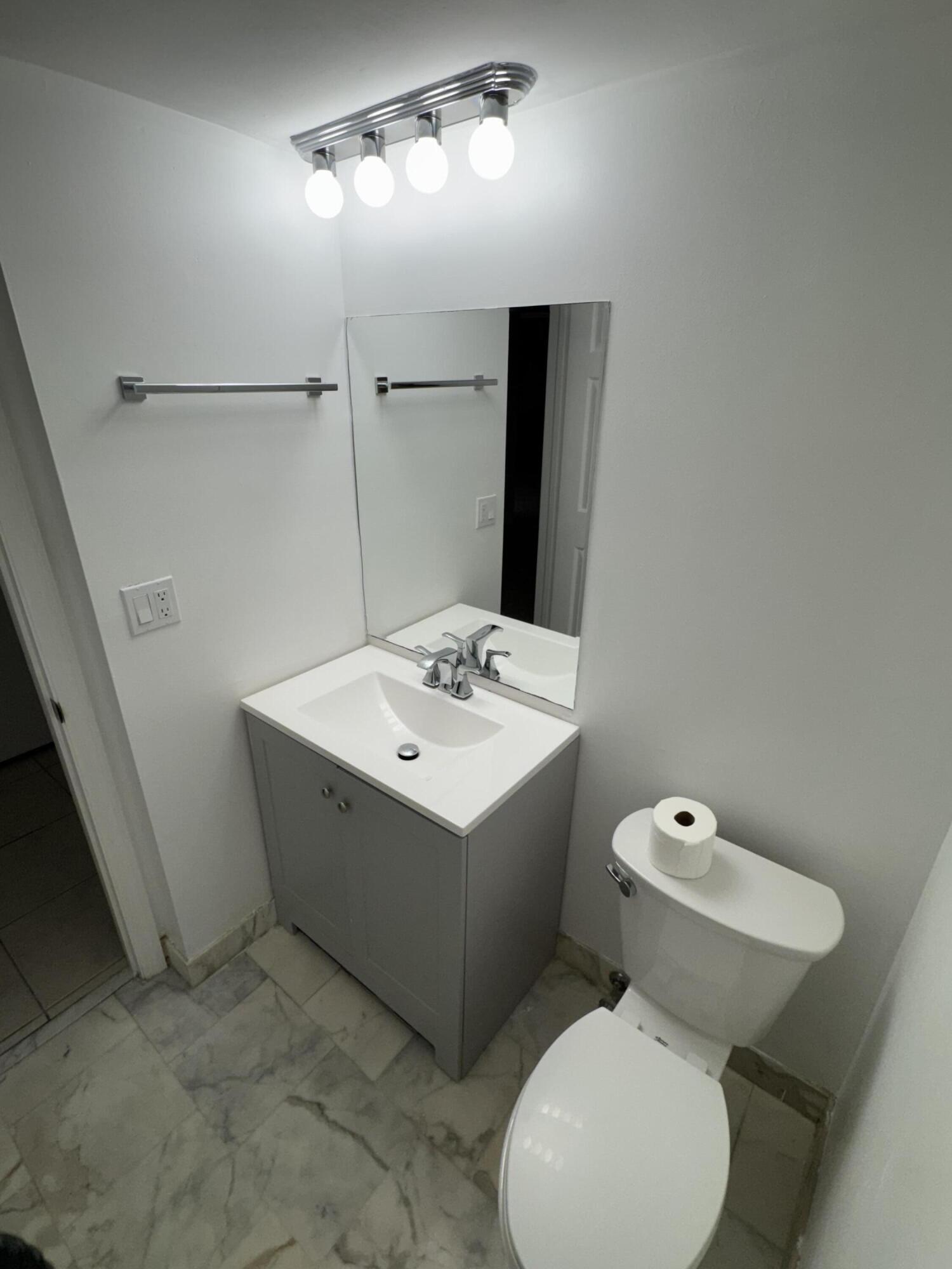 859 Jeffery Street, Unit 312 Boca Raton, FL 33487 - Photo 7 of 53 a bathroom with a sink toilet and mirror