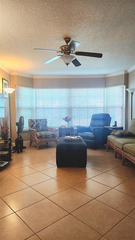 2270 Northeast 68th Street, Unit 1903 Fort Lauderdale, FL 33308 - Photo 4 of 7 a living room with furniture and a chandelier