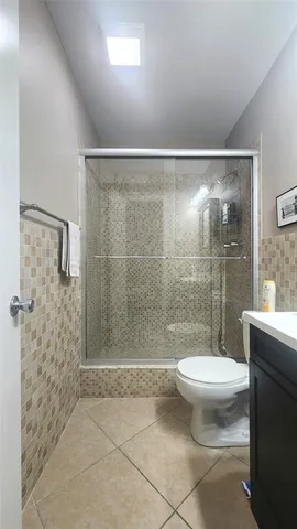 a bathroom with a shower and a toilet