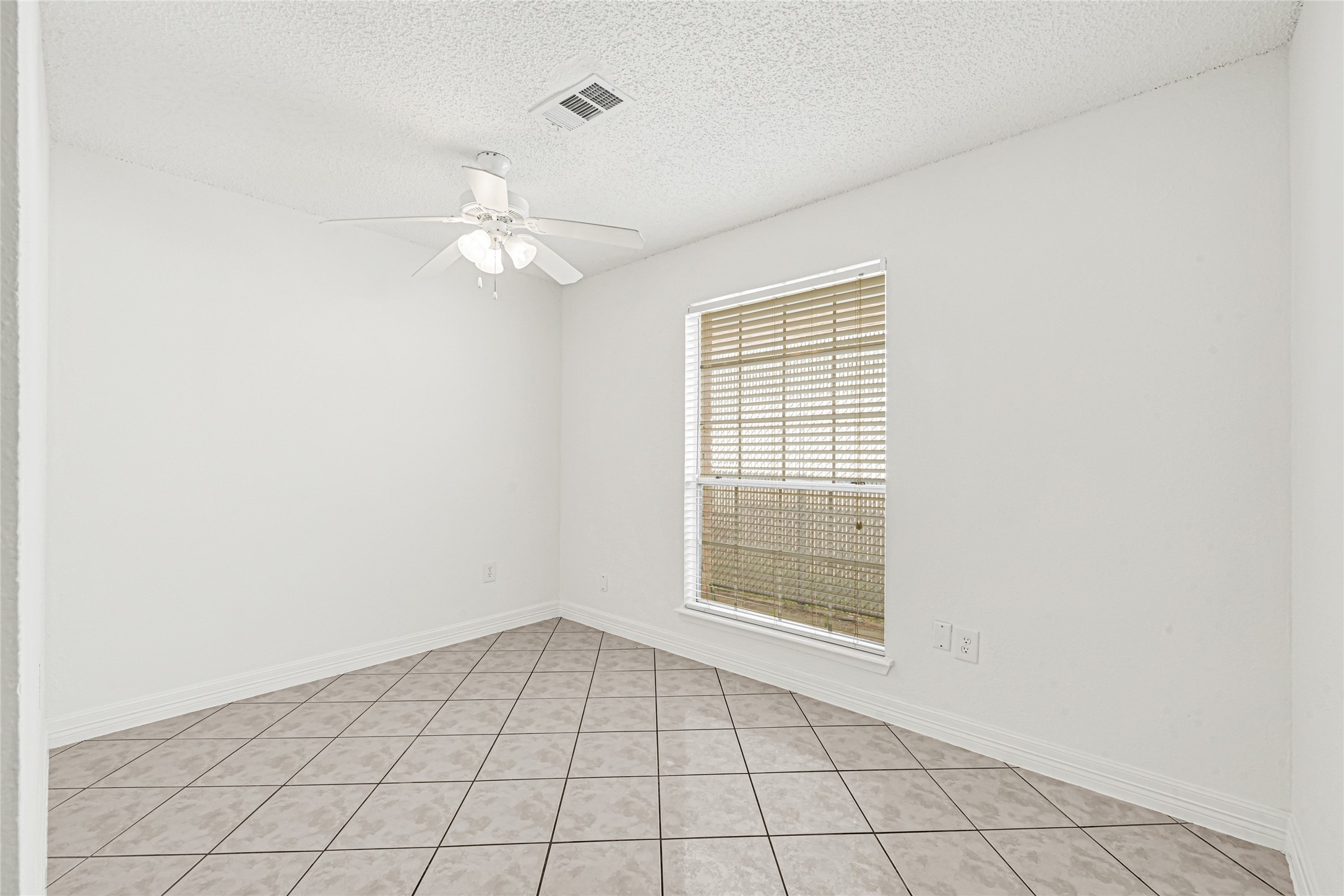 9208 Carousel Lane Houston, TX 77080 - Photo 16 of 31 an empty room with windows and fan