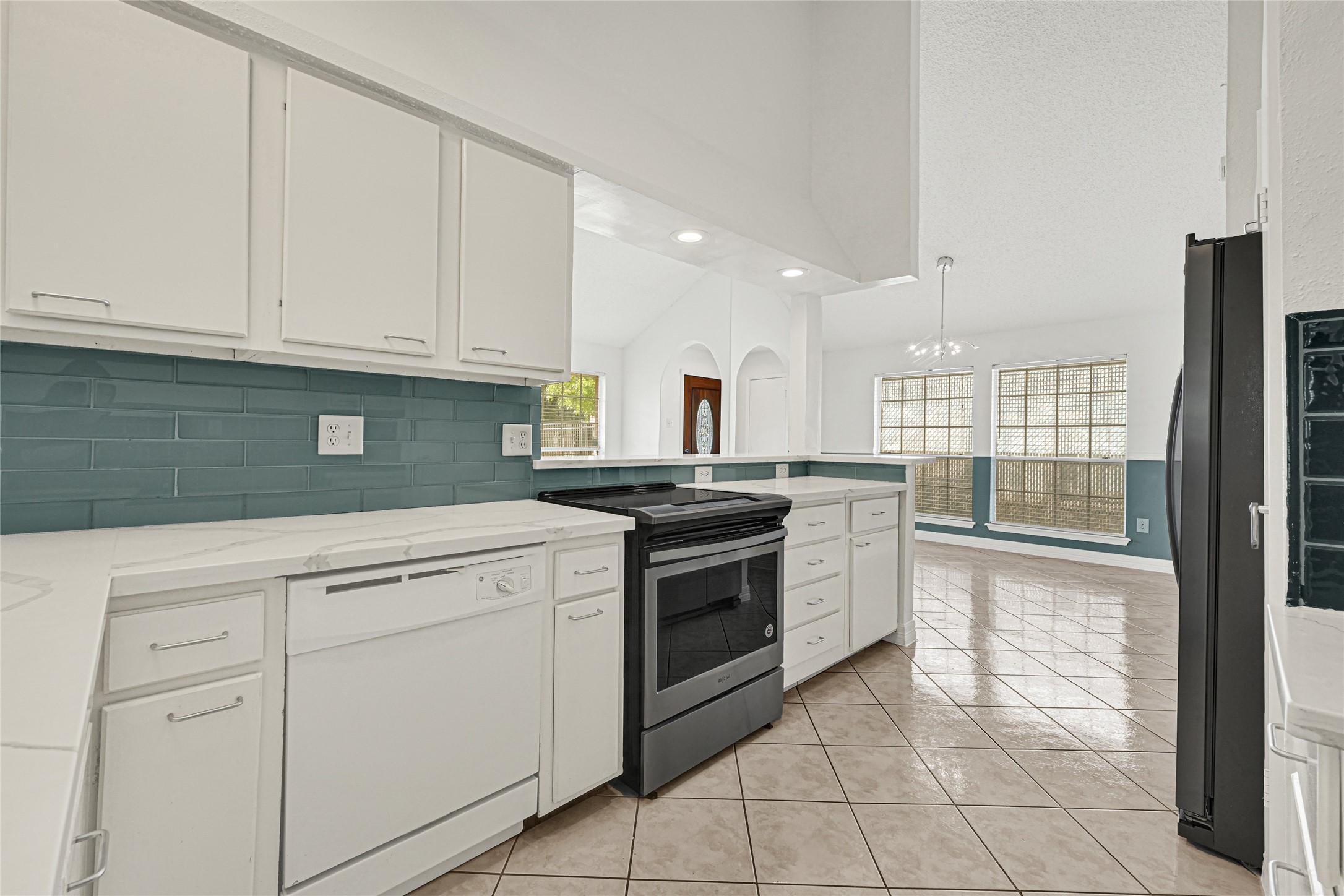 9208 Carousel Lane Houston, TX 77080 - Photo 17 of 31 a kitchen with granite countertop white cabinets and white appliances