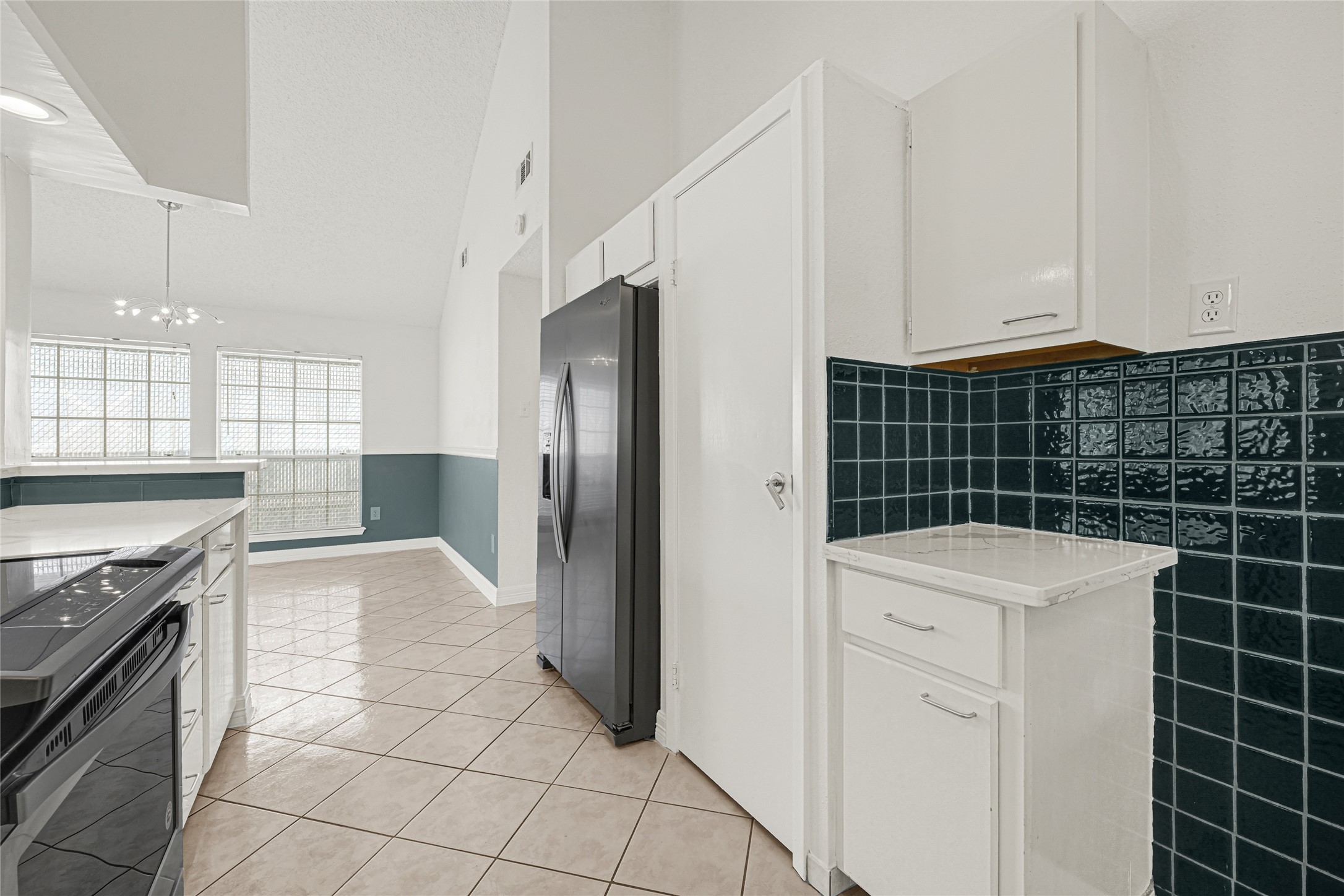 9208 Carousel Lane Houston, TX 77080 - Photo 18 of 31 a kitchen with appliances cabinets and a stove top oven