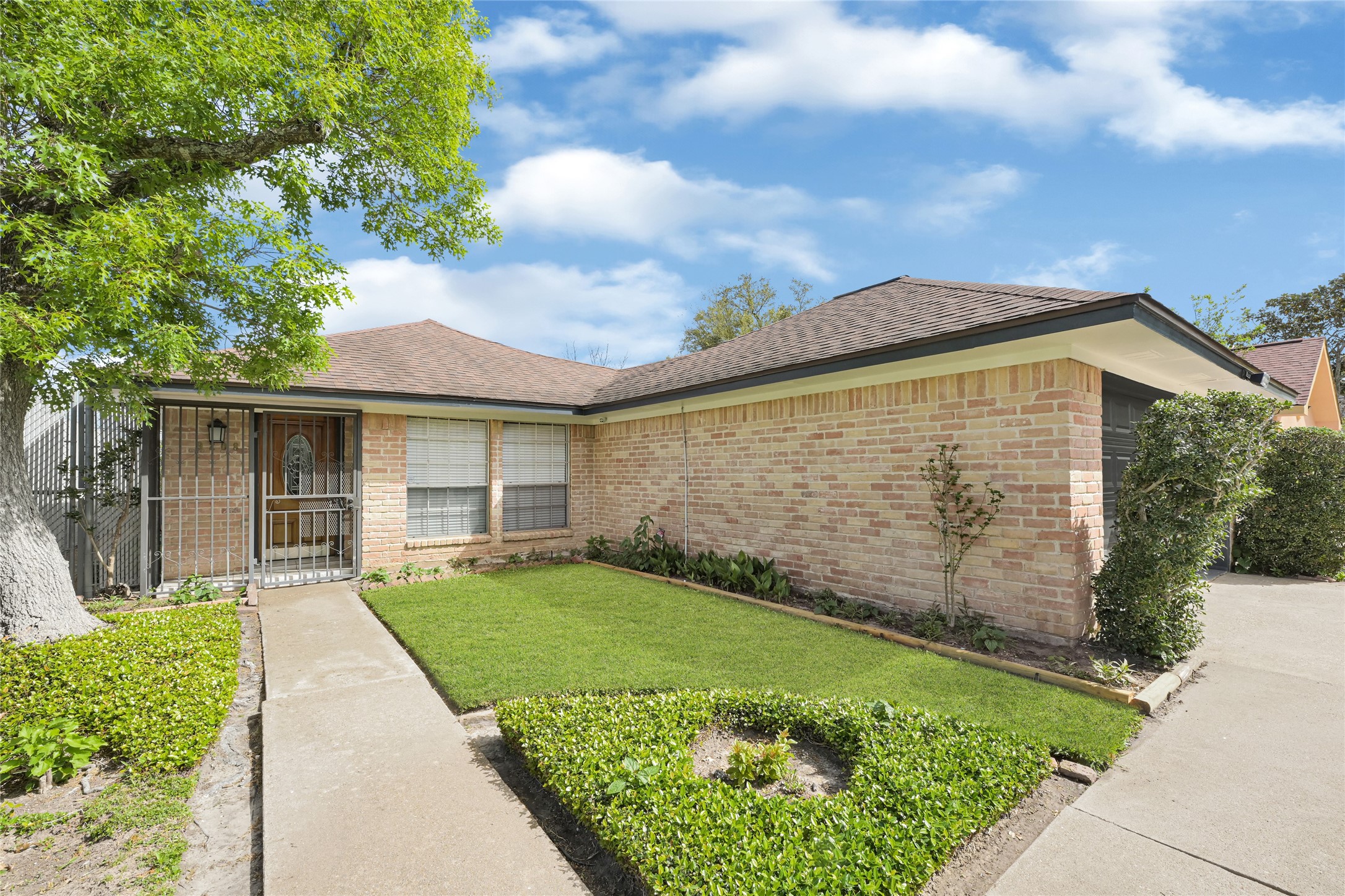 9208 Carousel Lane Houston, TX 77080 - Photo 3 of 31 a front view of a house with a garden