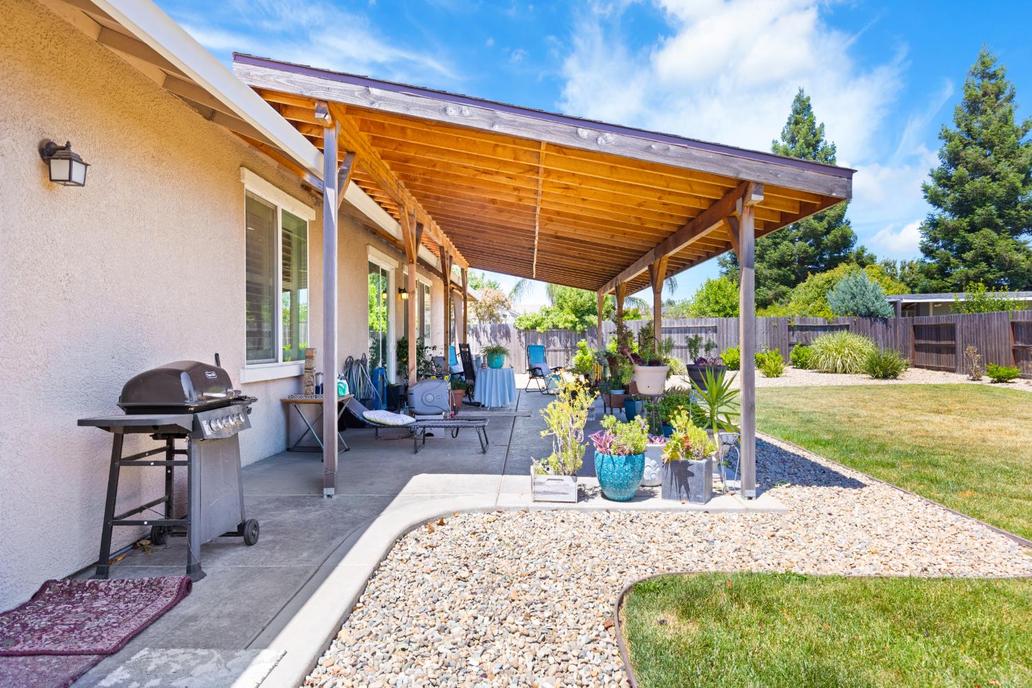 2011 Roy Ranch Way Plumas Lake, CA 95961 - Photo 32 of 49 a view of a patio with table and chairs under an umbrella